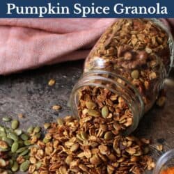 a jar of pumpkin granola on its side with granola spilling onto a table.