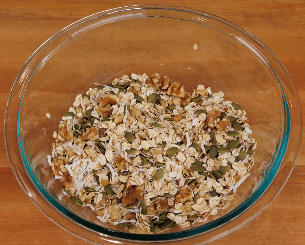 oats, nuts, coconut, and spices in a large mixing bowl