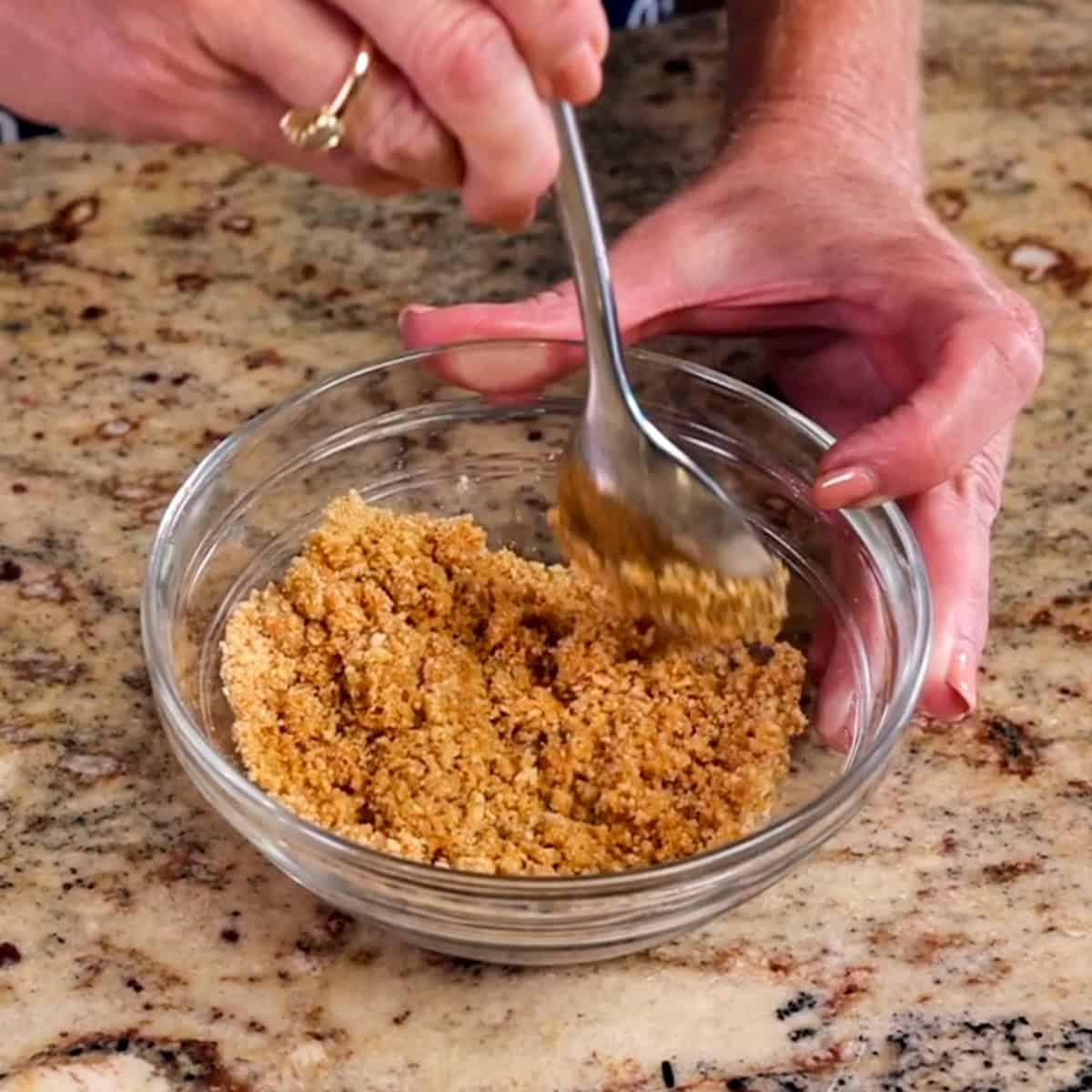 graham cracker crumbs, cinnamon and melted butter in a bowl.