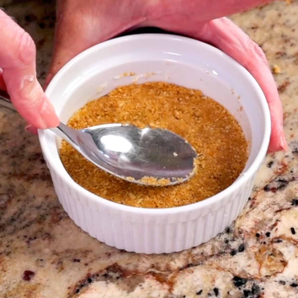 graham cracker crust in a small white ramekin.