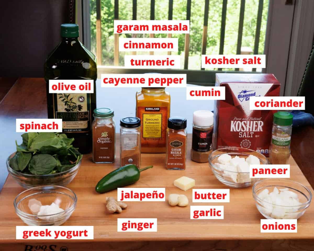 ingredients in saag paneer on a wooden cutting board