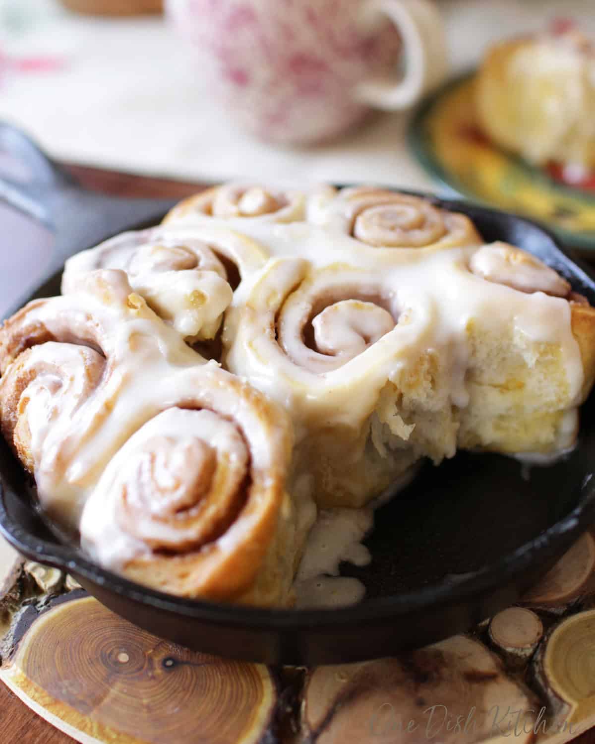 homemade cinnamon rolls in a small cast iron skillet.
