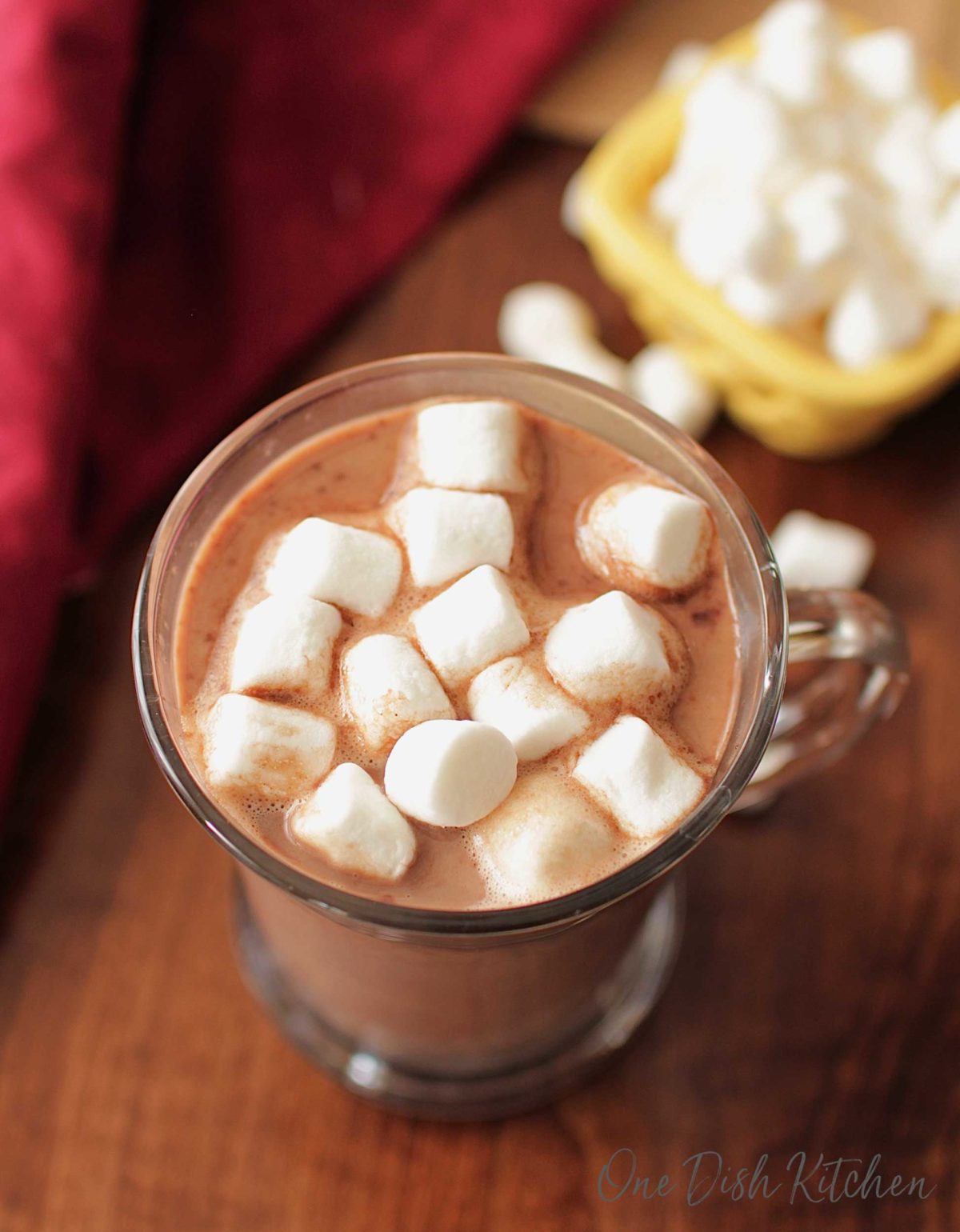 an overhead view of a mug of hot chocolate with marshmallows floating on top.