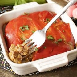 a small bacon cheeseburger meatloaf topped with a ketchup and mustard glaze in a small white baking dish.