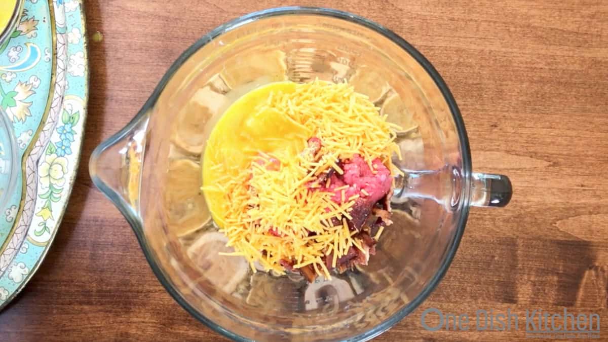 ingredients for a bacon cheeseburger meatloaf in a mixing bowl.