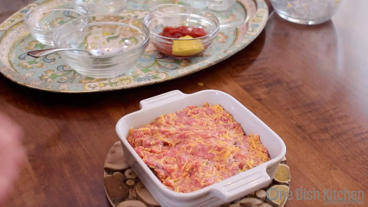 an unbaked bacon cheeseburger meatloaf in a small baking dish.