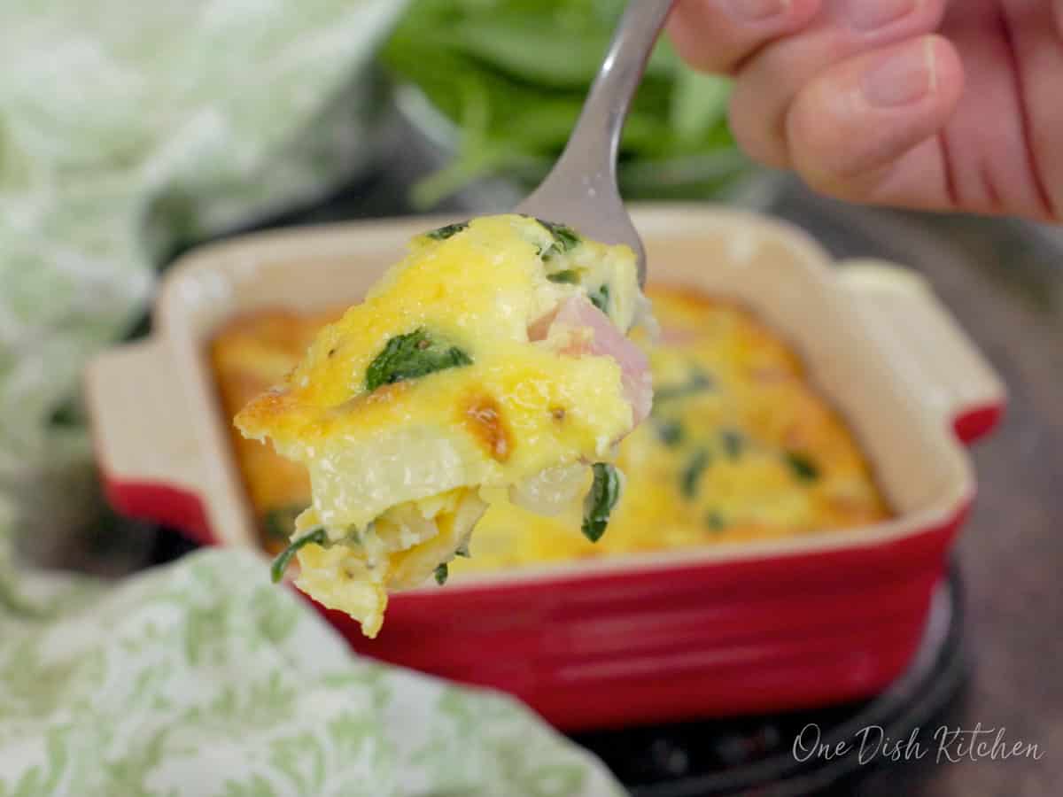 a crustless spinach quiche with a fork on the side.