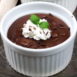 a small white ramekin filled with chocolate pudding