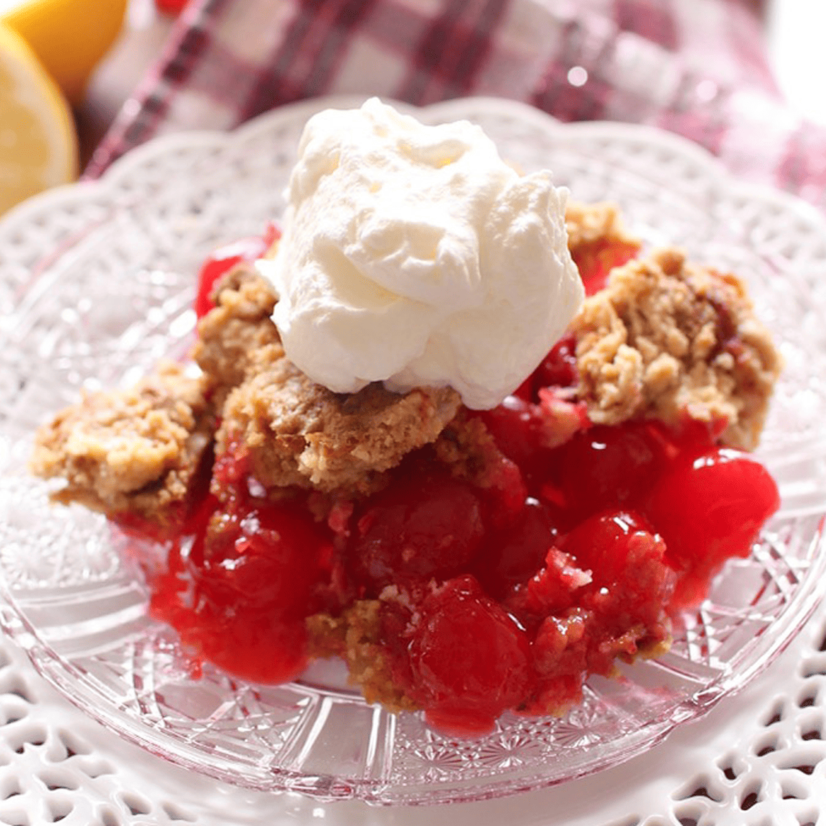 a slice of Cherry Dump Cake on a glass plate.