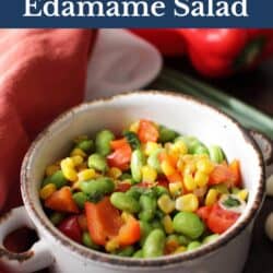 edamame salad in a white bowl with peppers and corn.