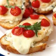 Caprese toast with green pesto and tomatoes on top