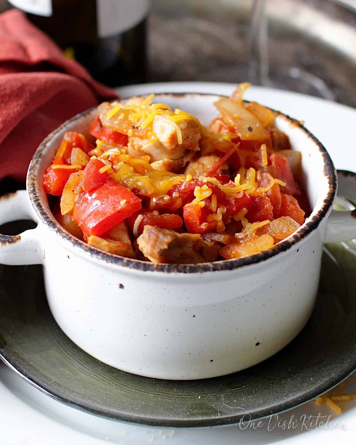 a single serving of chicken chili made with rotisserie chicken and topped with shredded cheese.