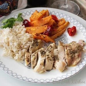 sheet pan chicken and vegetables on a white plate.
