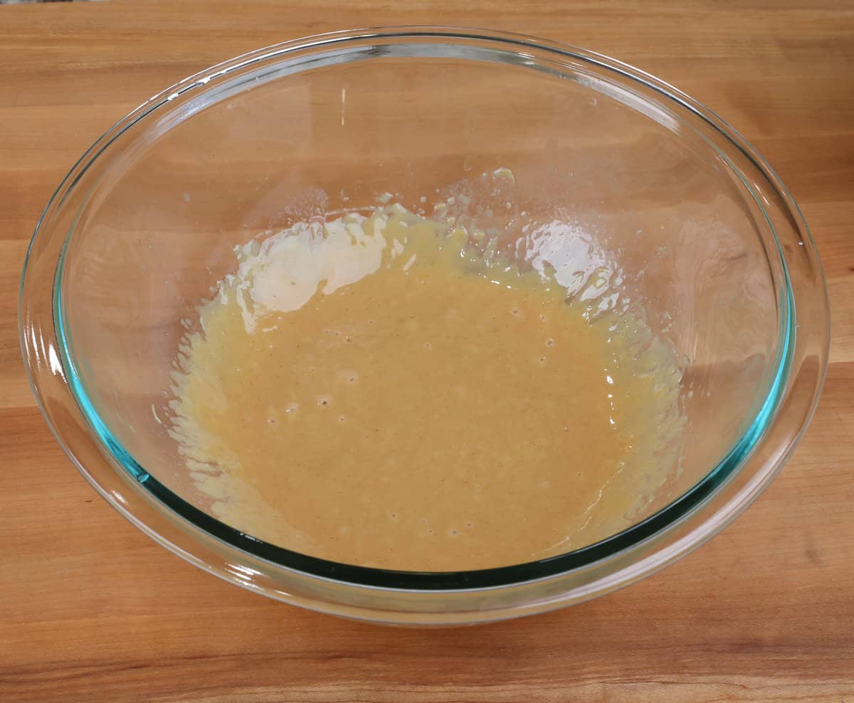 peanut butter and melted butter mixed together in a mixing bowl.