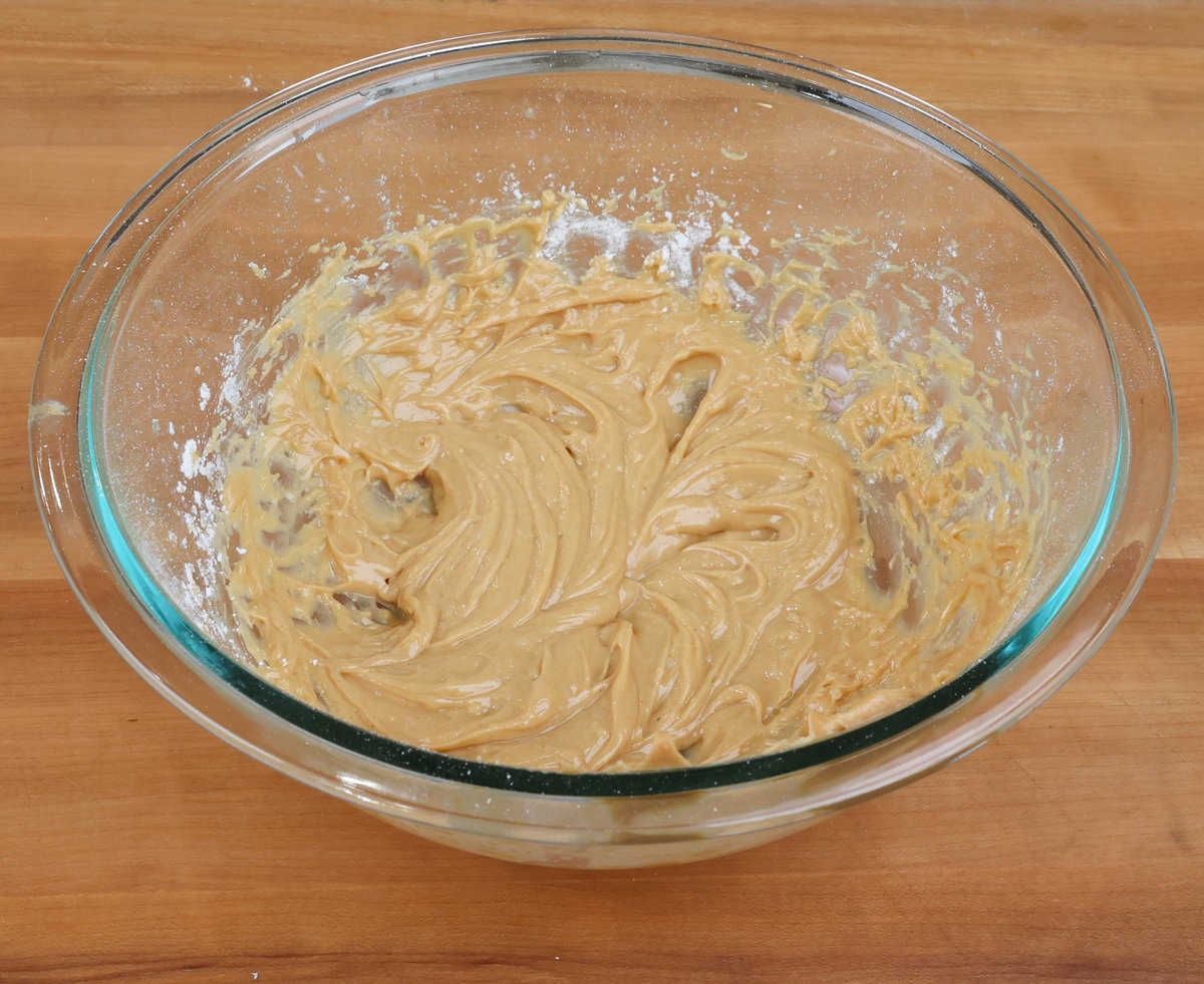 peanut butter, melted butter, and powdered sugar blended together in a mixing bowl.