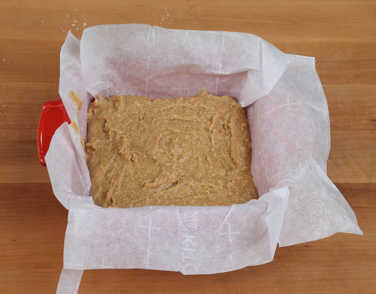 peanut butter bars in a lined baking dish.