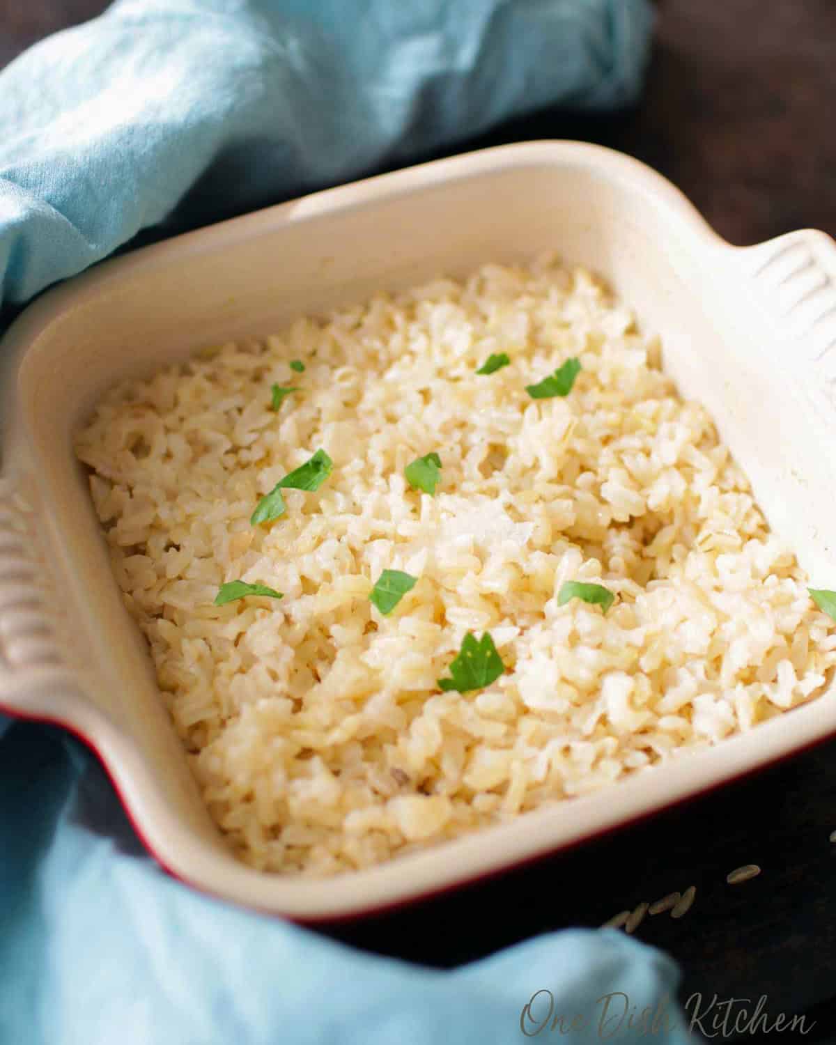 baked brown rice in a red baking dish.