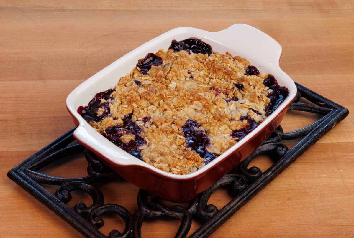 a hot, bubbly blueberry crumble in a small baking dish