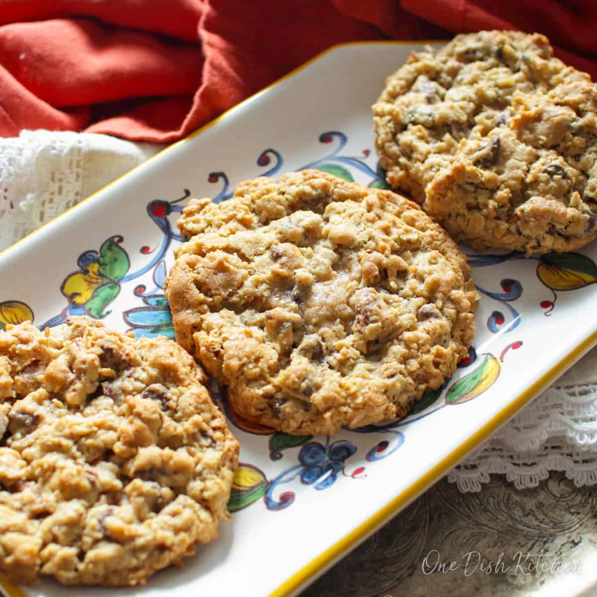 three large Laura Bush's cowboy cookies on a plate showing the crisp sides and the soft centers.