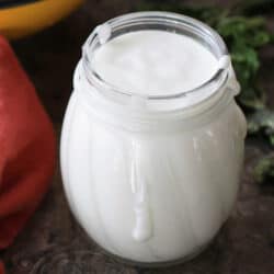 small jar filled with goat cheese dressing.