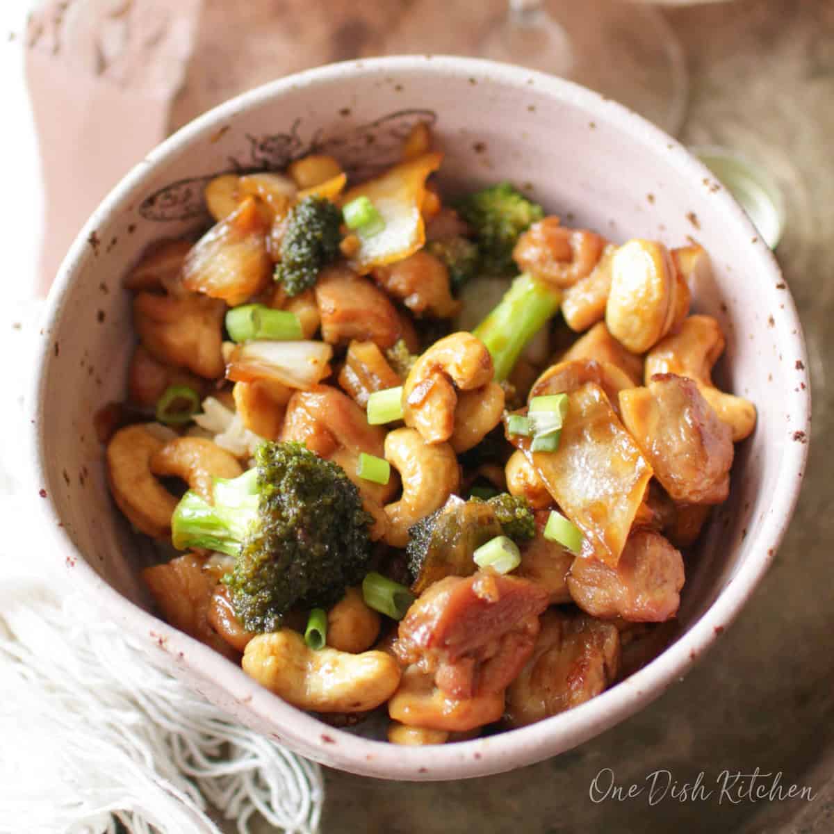 a bowl of cashew chicken with broccoli.