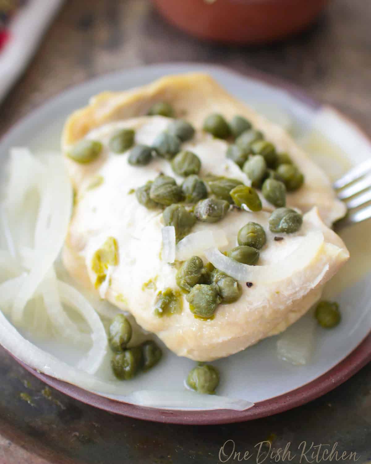 slow cooker chicken piccata with lemon caper sauce on a plate.