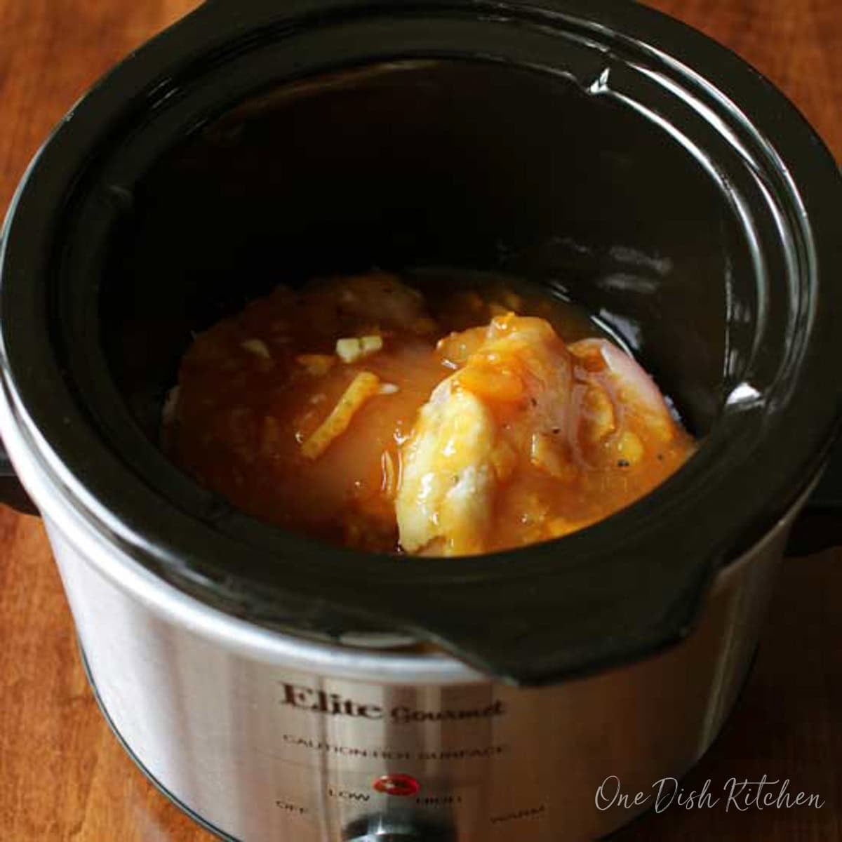 a single serving of orange chicken in a small slow cooker.