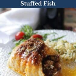 stuffed fish on a white plate next to a side of orzo pasta.