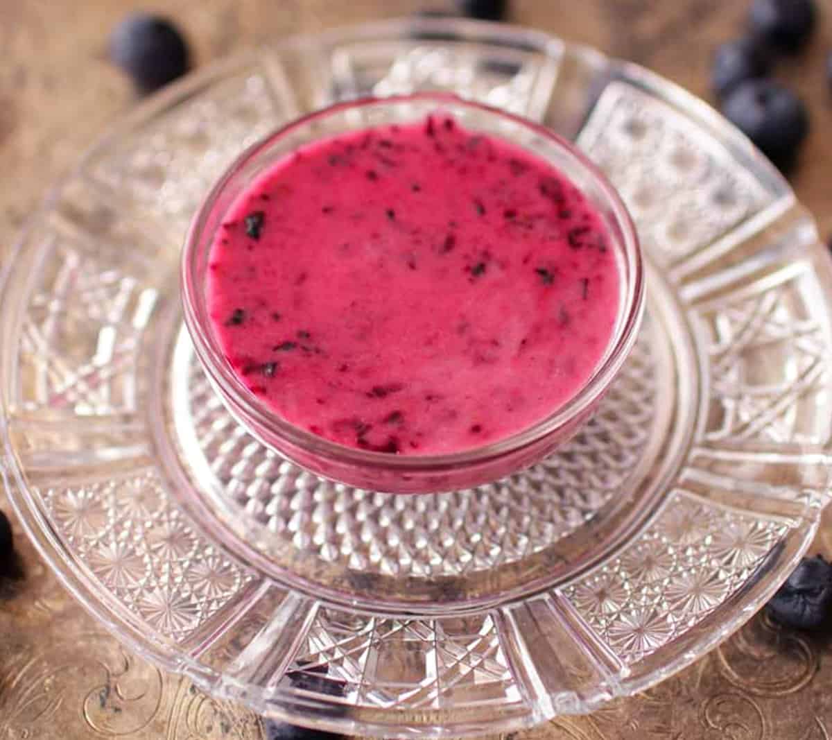 a bowl of blueberry vinaigrette on a table.