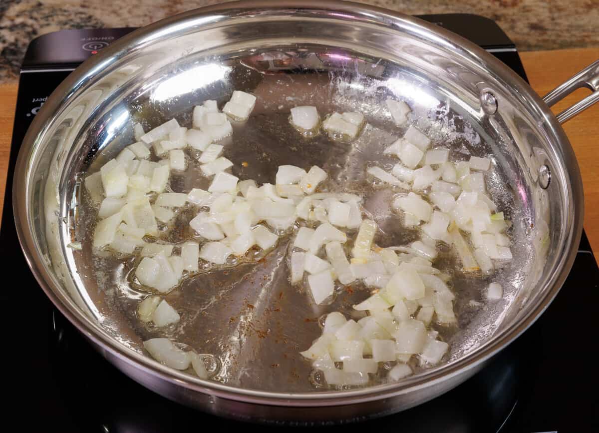 onions and garlic cooking in a skillet