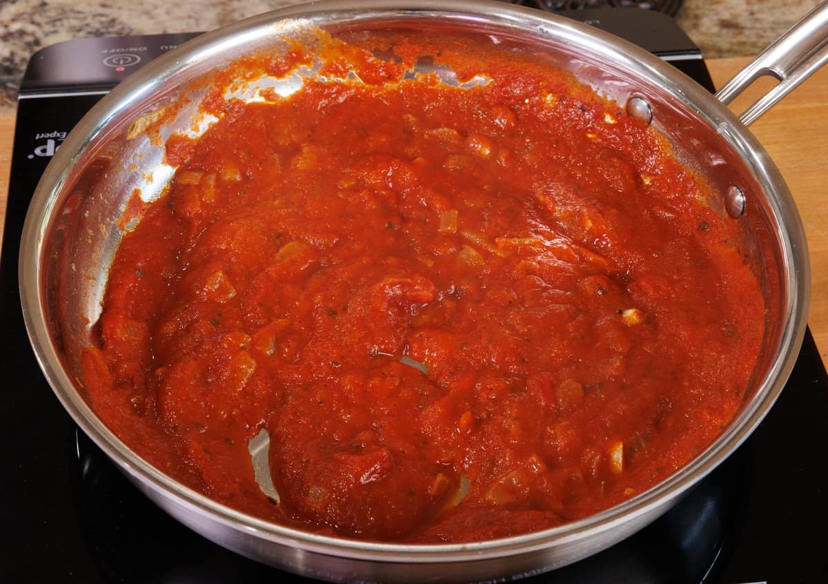 tomato sauce simmering in a small saucepan