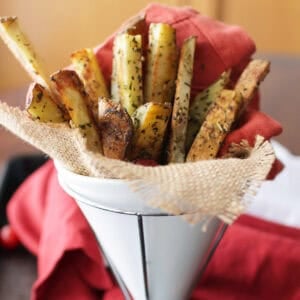 a small batch of french fries in a white container.
