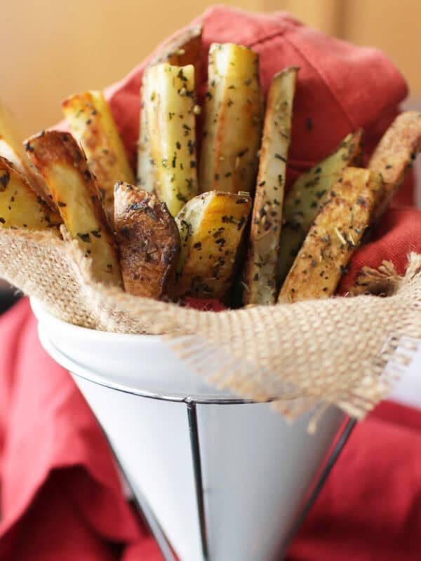 a small batch of french fries in a white container.