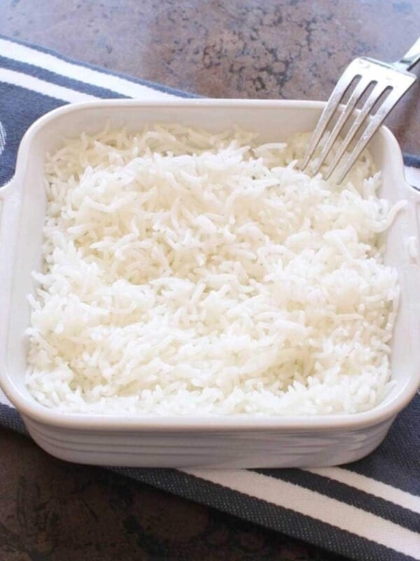 a bowl of rice with a fork on the side of the dish