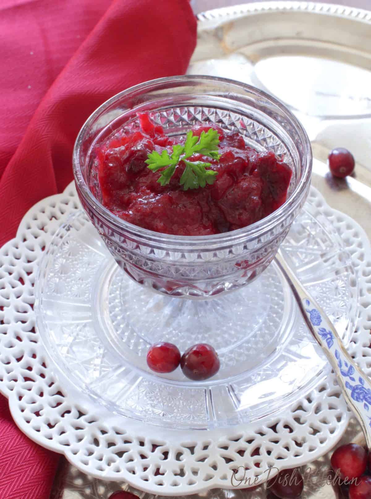 a small bowl of cranberry sauce next to a red napkin.