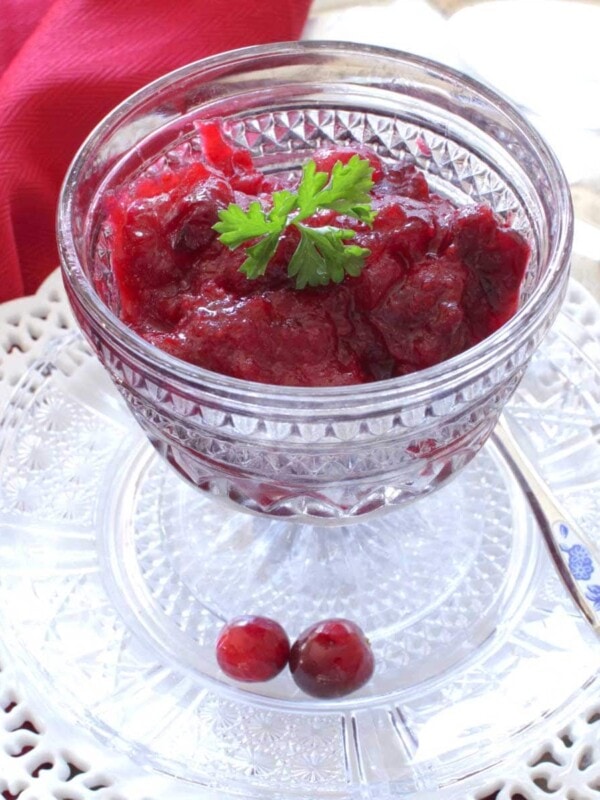a gray bowl of cranberry sauce next to a red napkin