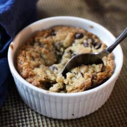 a spoon on the side of a deep dish chocolate chip cookie