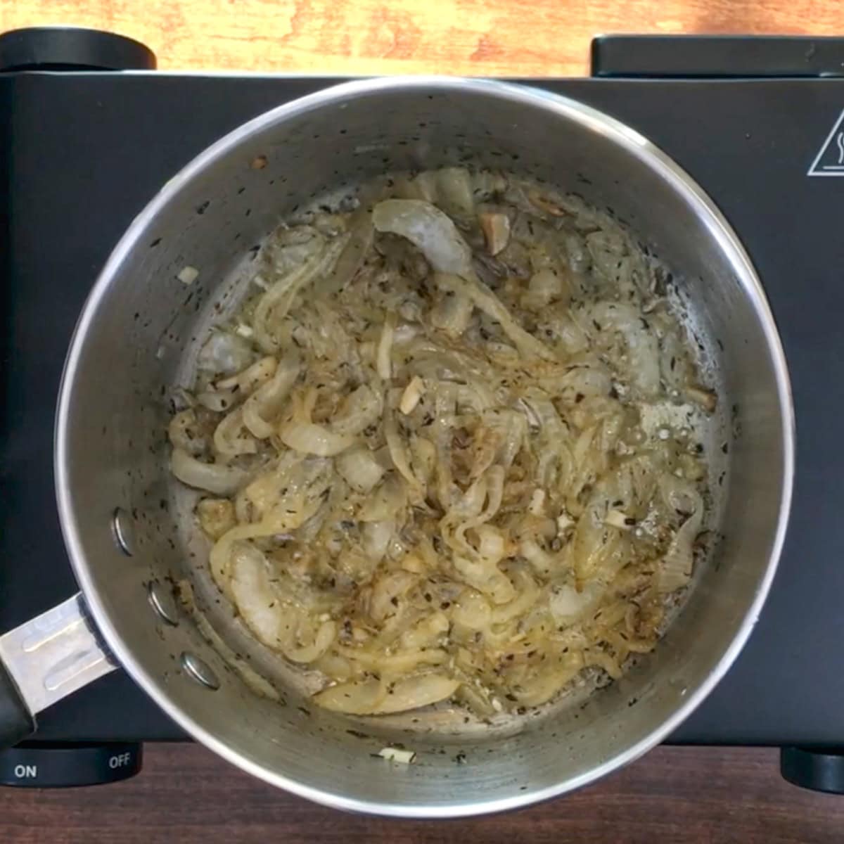 onions caramelizing in a pot.