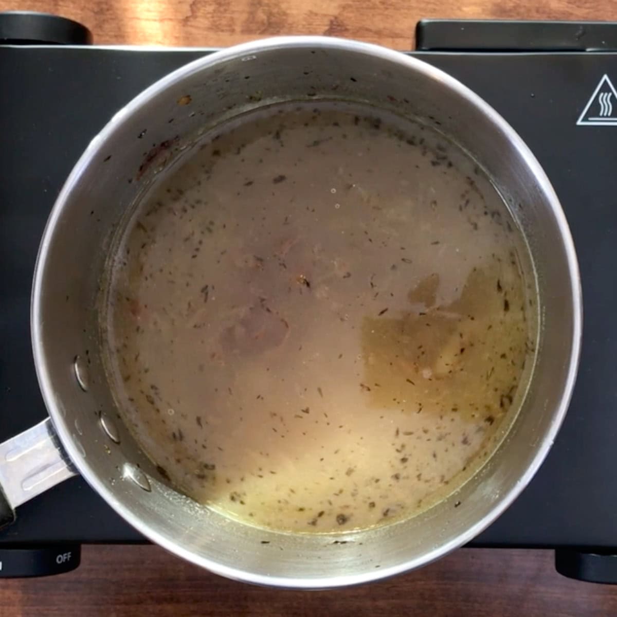 french onion soup simmering in a pot.