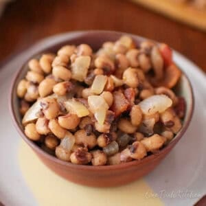 a small batch of black eyed peas with bacon in a bowl.