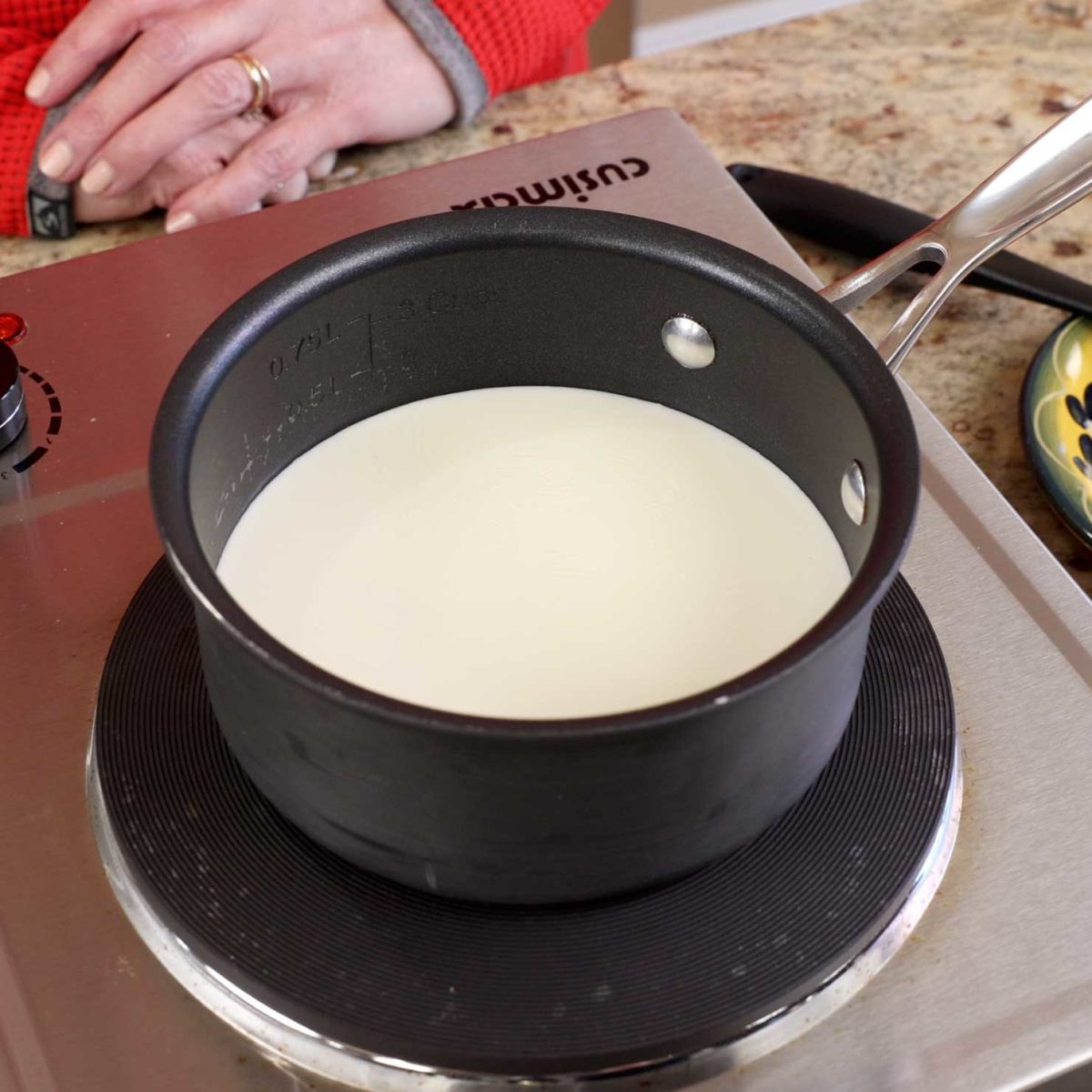 milk simmering in a small saucepan.