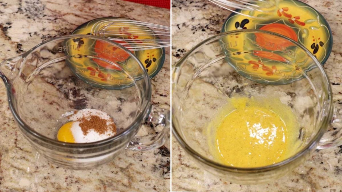 an egg yolk, nutmeg, and sugar in a small mixing bowl on a kitchen counter.
