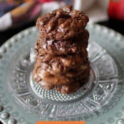 three flourless chocolate cookies on a plate.