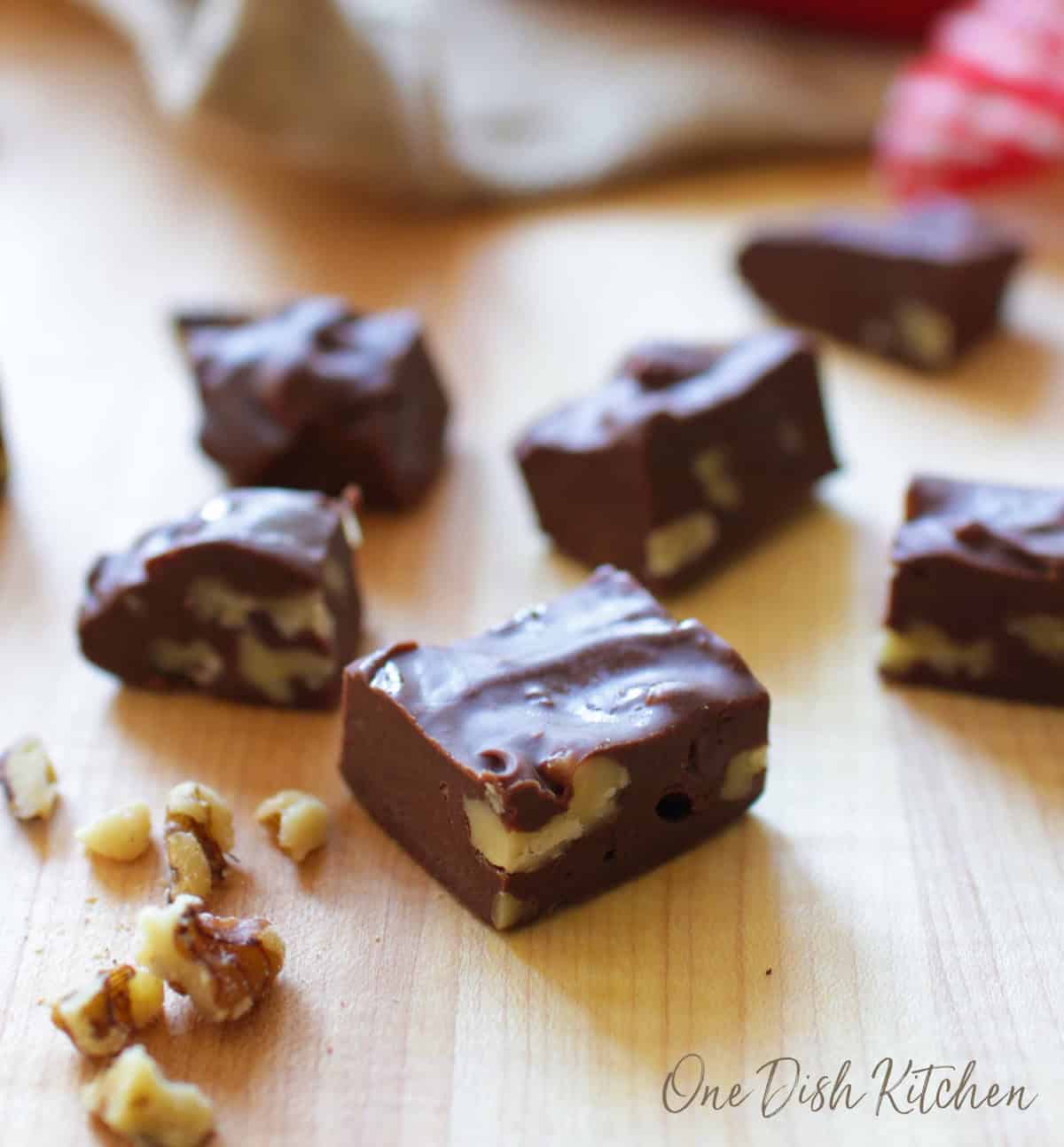 a small batch of fudge on a kitchen counter surrounded by nuts.