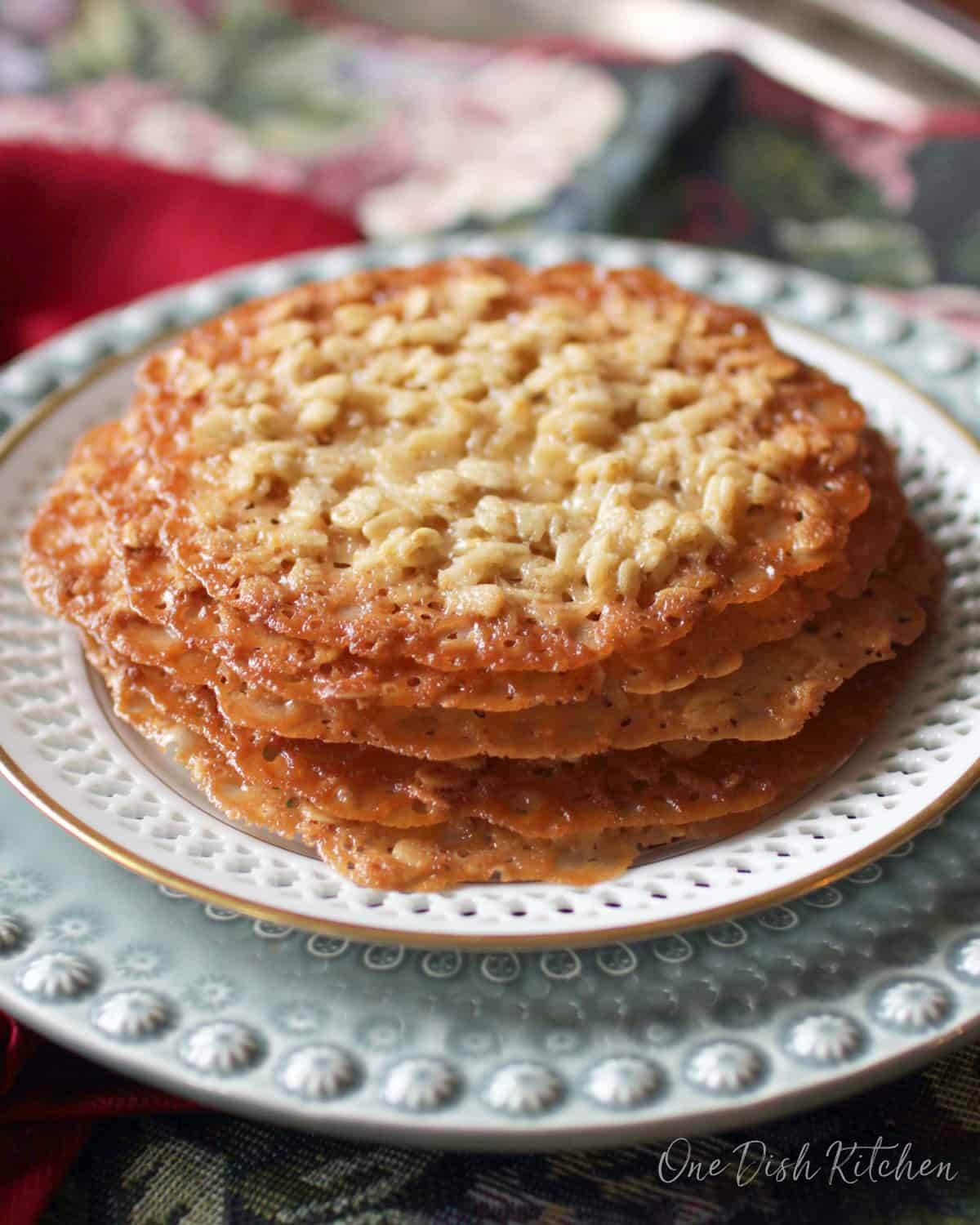 a small batch of lace cookies on a white plate.