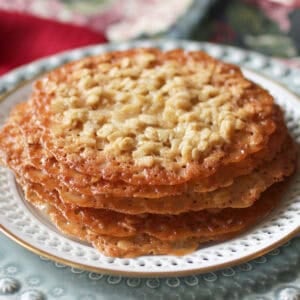 a small batch of lace cookies on a white plate.