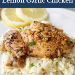 lemon chicken with garlic on top over a bed of orzo pasta.