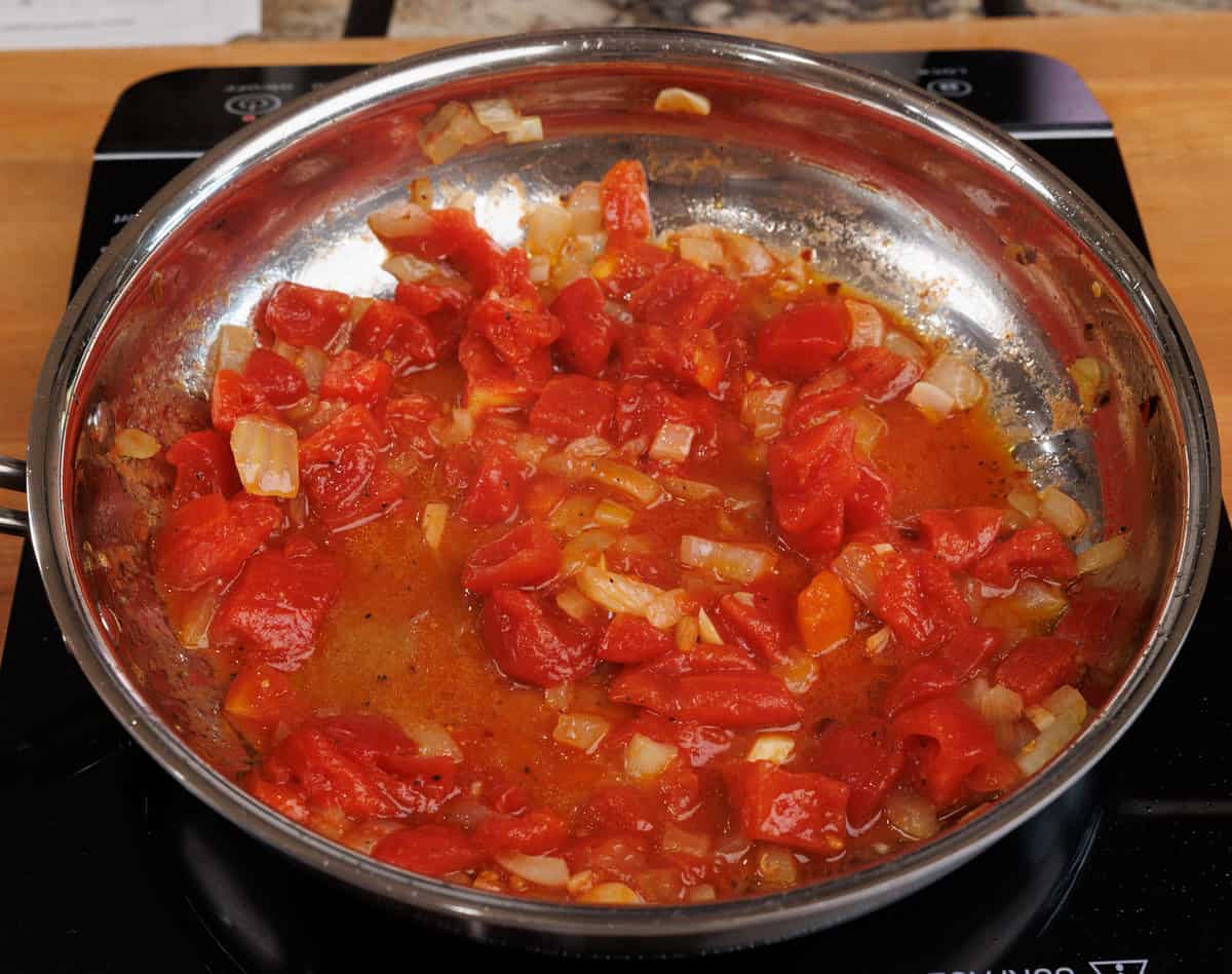 canned tomatoes simmering in a skillet