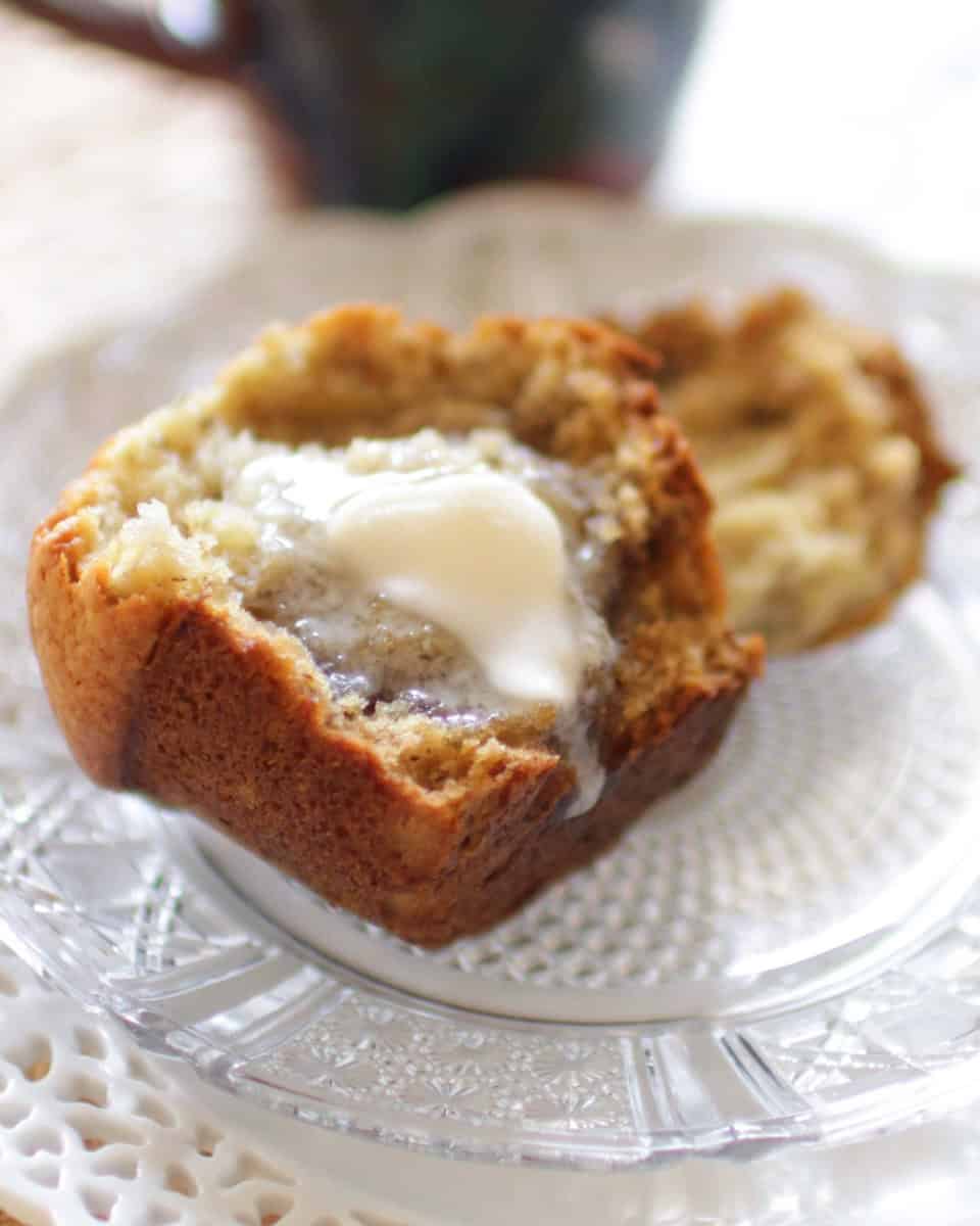 Butter melting on a muffin half and dripping onto the plate.