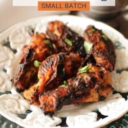 BBQ chicken wings on a white plate.